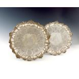 A pair of George IV silver salvers, by John Mewburn, London 1824, circular form, shell and scroll