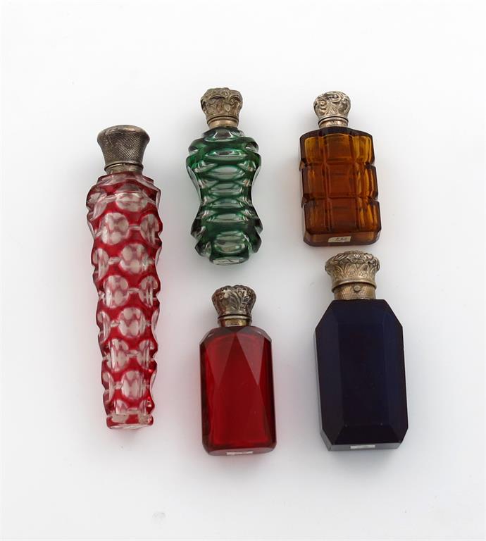 A collection of five Victorian silver-mounted coloured glass scent bottles, comprising: one with