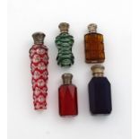 A collection of five Victorian silver-mounted coloured glass scent bottles, comprising: one with