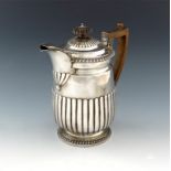 A George IV silver hot water pot, by Emes and Barnard, London 1818, circular form, part-fluted