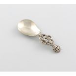 By The Artificer's Guild, an Arts and Crafts silver caddy spoon, London 1929, spot-hammered pear-