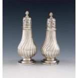 A pair of Victorian silver pepper pots, London 1885, fluted baluster form, the pull-off covers