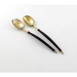 A pair of Victorian silver-gilt salad servers, by George Adams, London 1874, the tapering socket