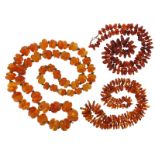 A graduated yellow amber bead necklace, 100cm, 190g. And two other amber bead necklaces. 86g (2).