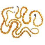 Three graduated amber bead necklaces, 169g in total.