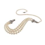 A cultured pearl necklace, the single row divided by rose~cut diamond~set spray clasps attached to a