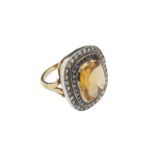 A citrine sapphire and diamond ring, the citrine is set with a calibre~cut sapphire surround and a