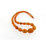 A graduated amber bead necklace, 66cm, 51g.