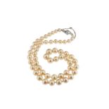 A single row cultured pearl necklace, with a baguette shaped and circular cut diamond clasp. 55cm