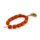 AN AMBER BEAD BRACELET 20TH CENTURY Comprising twelve cylindrical beads, 63g, 11cm dia.  二十世紀