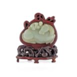 A CHINESE PALE CELADON JADE PLAQUE 18TH/19TH CENTURY Carved as a recumbent horse, with a monkey