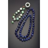 TWO CHINESE LAPIS LAZULI BEAD NECKLACES QING DYNASTY Comprising sixty-six spherical beads taken from