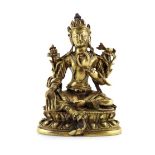 A SMALL CHINESE GILT BRONZE FIGURE OF GREEN TARA 18TH/19TH CENTURY Seated on a double lotus base