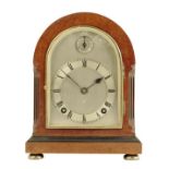 A quarter chiming amboyna wood mantel clock of small size, the 4.5 inch silvered dial with slow /