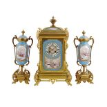 A good porcelain and gilt brass clock garniture with unusual snow scenes, striking movement numbered