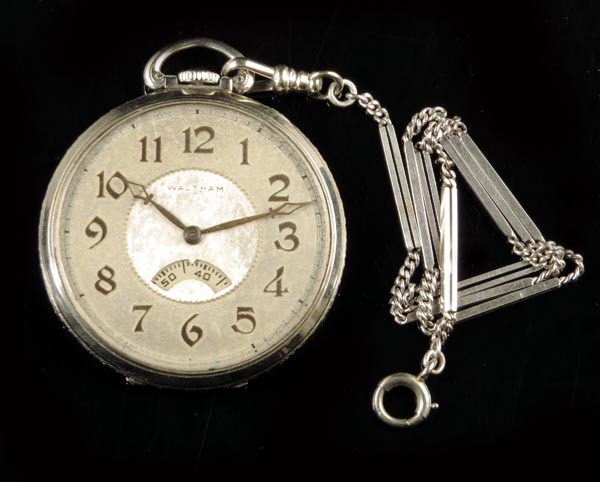 An American 14k gold dress watch and chain, silvered dial signed Waltham with rotating seconds