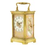 A reproduction porcelain mounted carriage timepiece, cylinder platform, in a case with reeded bands,