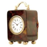 λ A miniature 9ct gold mounted tortoiseshell carriage timepiece, circular white enamel dial, lever