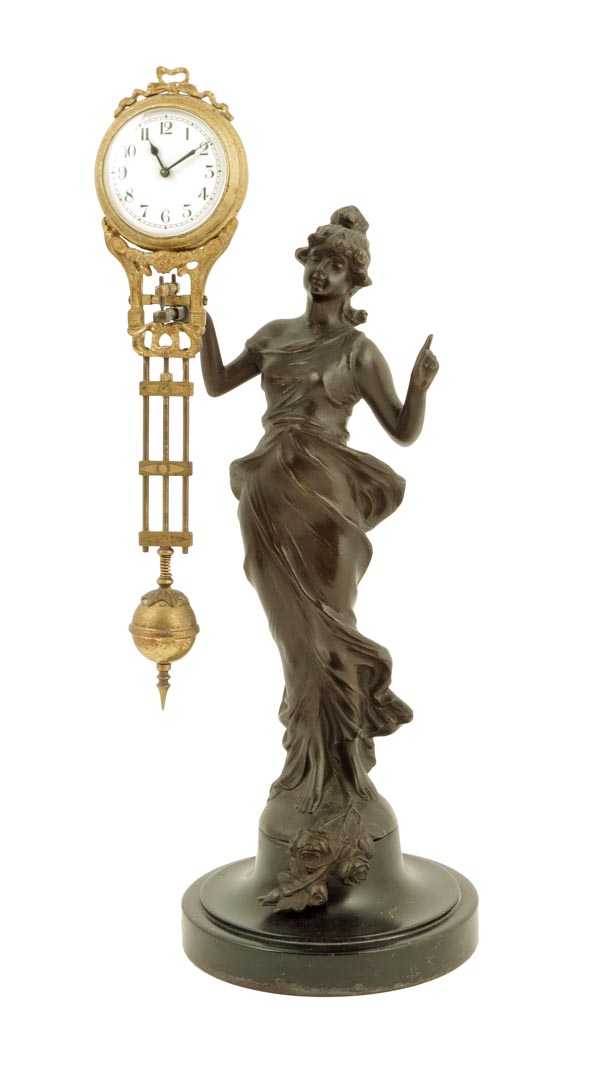 A German mystery timepiece, the swinging pendulum with white enamel dial, supported on the arm of