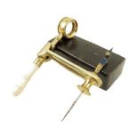 λ A lacquered brass simple microscope, with lens and turned ivory handle, in pressed card case,