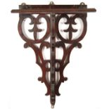 A George III mahogany bracket, with pierced supports and a rectangular top, 19in (48cm) high,