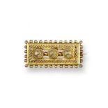 A late Victorian filigree gold ring, set with garnets and seed pearls. Size O 1/2. An Etruscan style