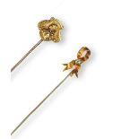An Art Nouveau gold stickpin, depicting the profile of a young girl and set with a small diamond,