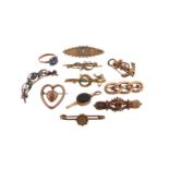 A rectangular cut sapphire and six white stone set gold rings, a heart-shaped gold brooch suspending