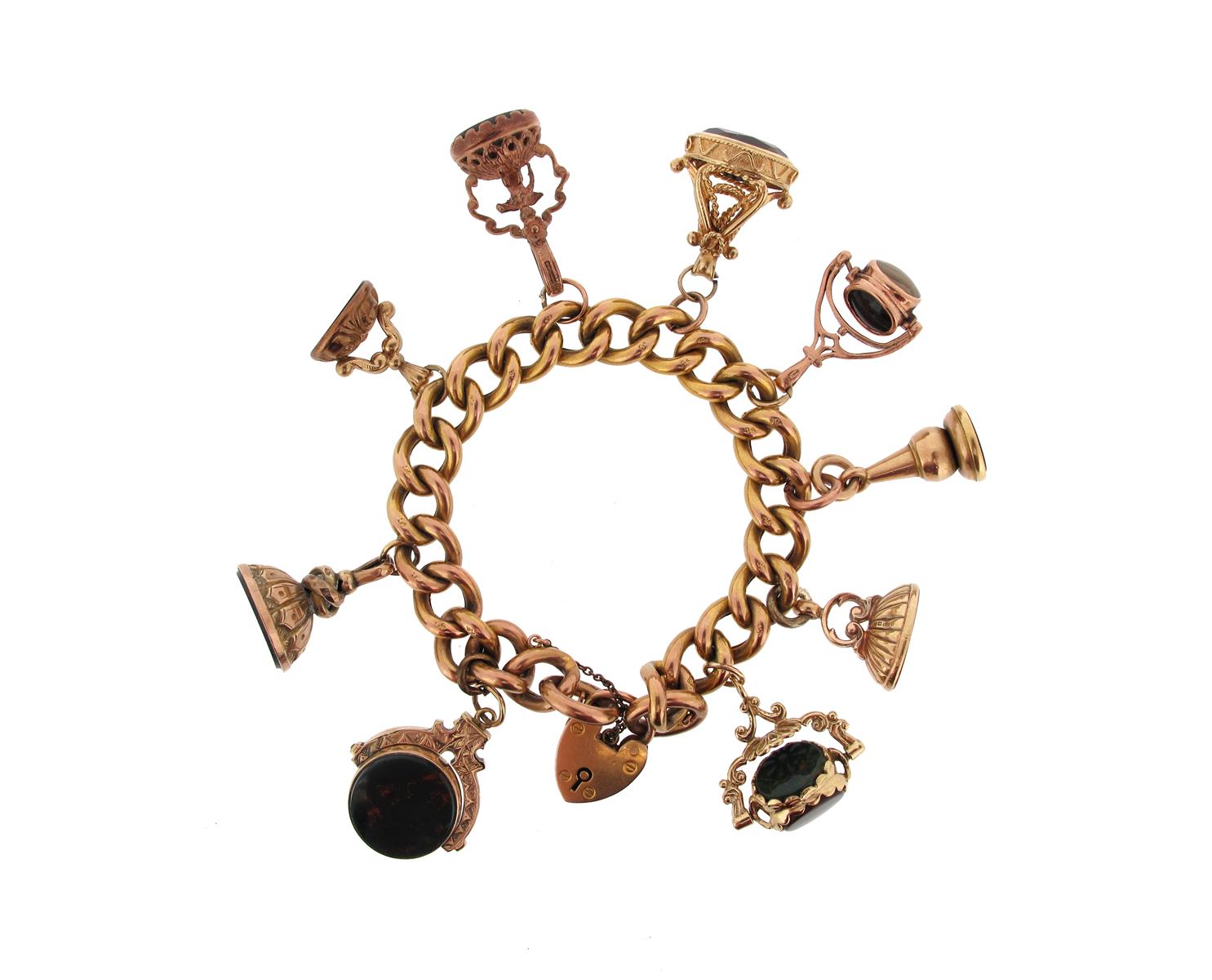 A gold charm bracelet, the 9ct gold curb link bracelet mounted with assorted gold charms. 60g in