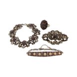 A garnet-set cluster ring, a garnet-set open work scroll brooch with enamel decoration and