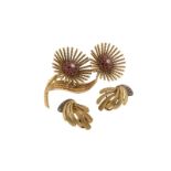 A gold stylised double flower head brooch, the centres pavé set with a diamond within ruby