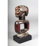 A Luba divination implement, D.R. Congo, with a Janus head finial, one with a beard, 19.5cm high, on