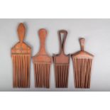 Four Solomon Islands wood combs, with incised decoration filled with nut paste, 21.5cm - 28cm