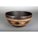 A West African wooden bowl, with incised decoration, with native staple repairs, 36.5cm diameter.