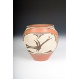 A Zia pottery jar, painted in a deep orange and black over a white slip, with two panels each with a