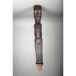 A Batak standing male guardian figure, Indonesia, with inlaid bone eyes, the chest with a recessed