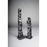 A Northwest Coast argillite totem, carved with a bear, a raven with human head in it's beak and a