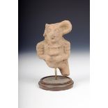 A Costa Rica pottery jaguar warrior fragment, 12.5cm high, on a stand.