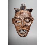 A Chokwe small mask, D.R. Congo, with a pricked cross symbol to the forehead, black stain