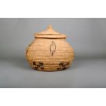 A coil basket and cover, with geometric symbols, 30.5cm high. (2) Provenance Dr James Spillius,