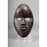 A Dan mask, Ivory Coast, with applied nails, 21.5cm high.