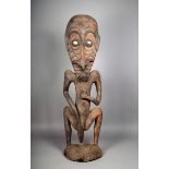 A Papua New Guinea standing ancestor figure, with shell eyes, 123.5cm high.