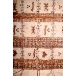 A Tonga tapa cloth, divided into squares with symbols, bands of text and foliage, 250 x 175cm,
