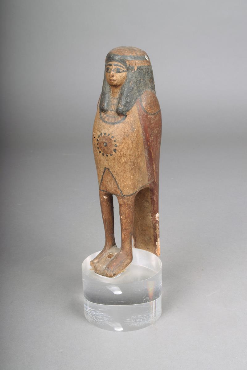 An Egyptian Ba bird, carved wood with gesso and painted, the crown of the head and base, pierced,