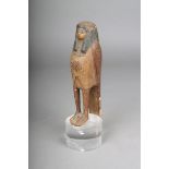 An Egyptian Ba bird, carved wood with gesso and painted, the crown of the head and base, pierced,