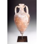 A Roman pottery amphora, 61cm high, on a stand. (2)