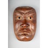 A Japanese Noh mask, of otokomen type, carved wood with gilt highlights, 20.6cm high. Provenance