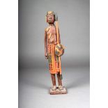 A Madagascan warrior figure, painted and with beads and cloth, 35cm high.