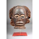 A Chokwe mask, D.R.Congo, with a horizontal beard, filed teeth and coffee bean eyes, pierced ears