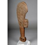 A Maori short club, wahaika, carved wood with grooves and notches, the curved inside edge with a